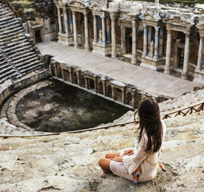 Visitor overlooking an ancient theatre at Ephesus