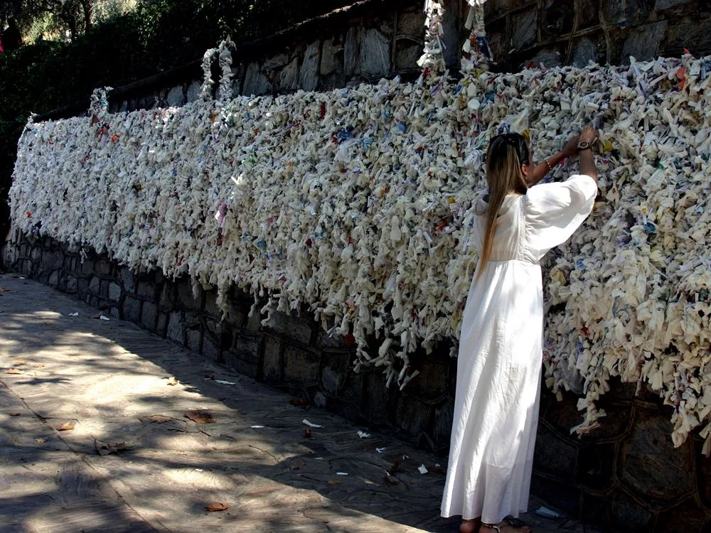Visitor at the wishing wall near the House of the Virgin Mary