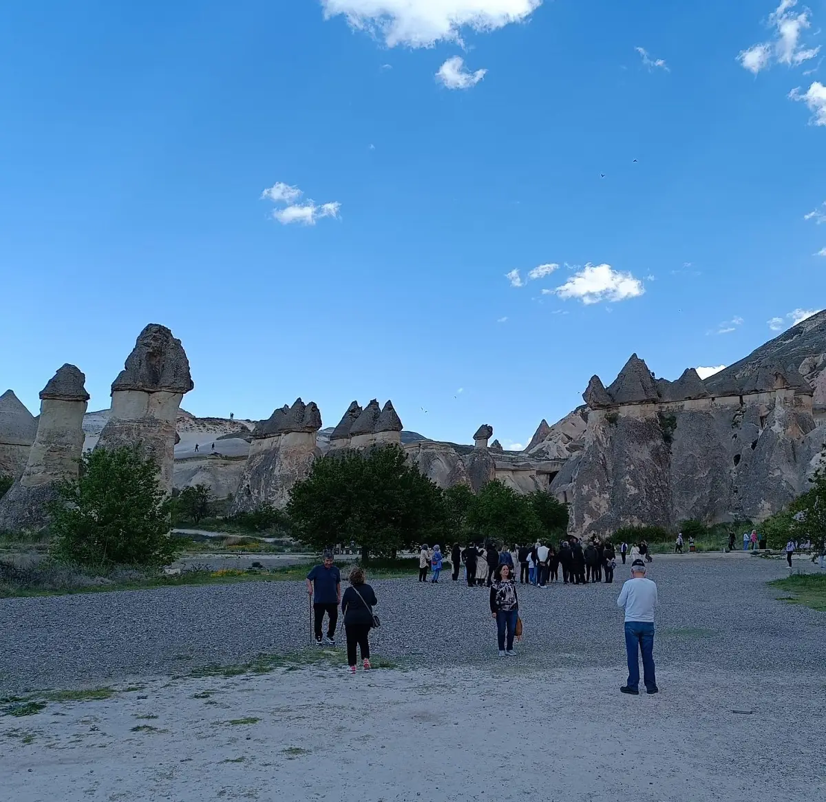 Visitors walking among the fairy chimneys at Pasabag